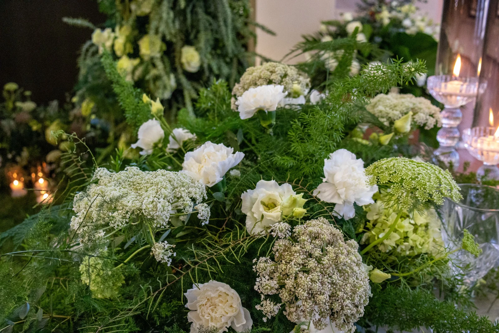 Allestimento floreale naturale con foglie e verdi intensi  Installazione floreale verde per matrimonio scenografico